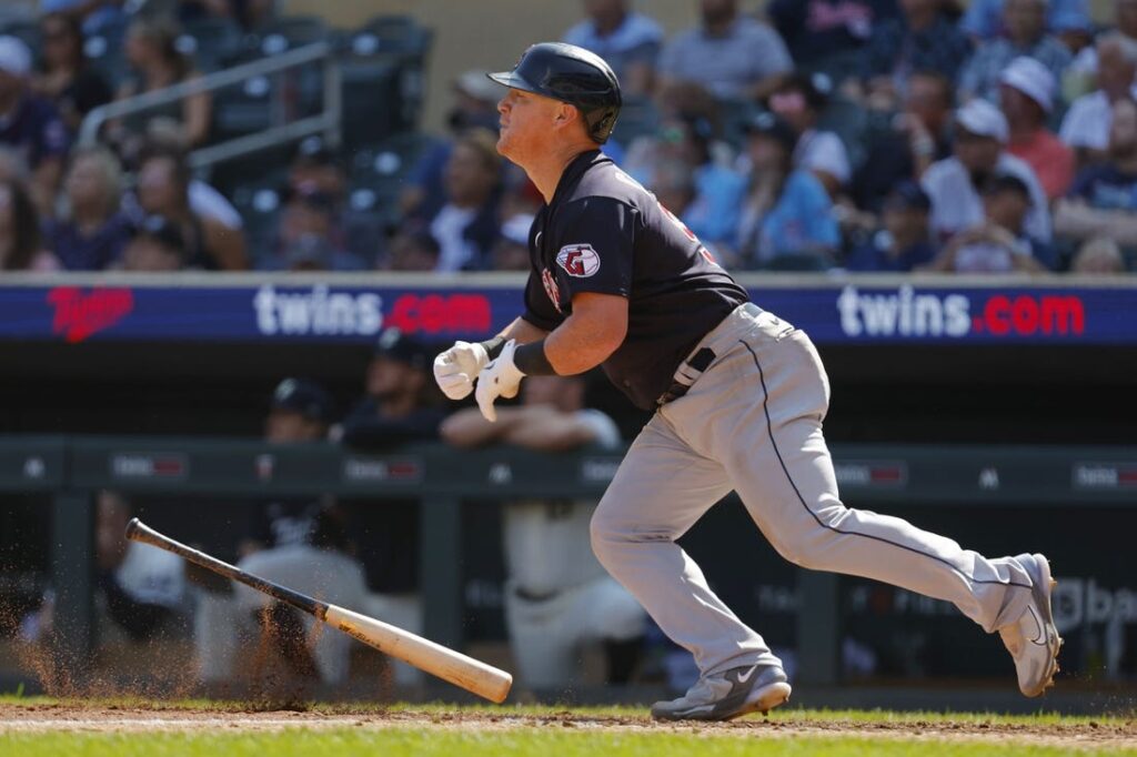 Texas Rangers' Kole Calhoun follows through on a run-scoring