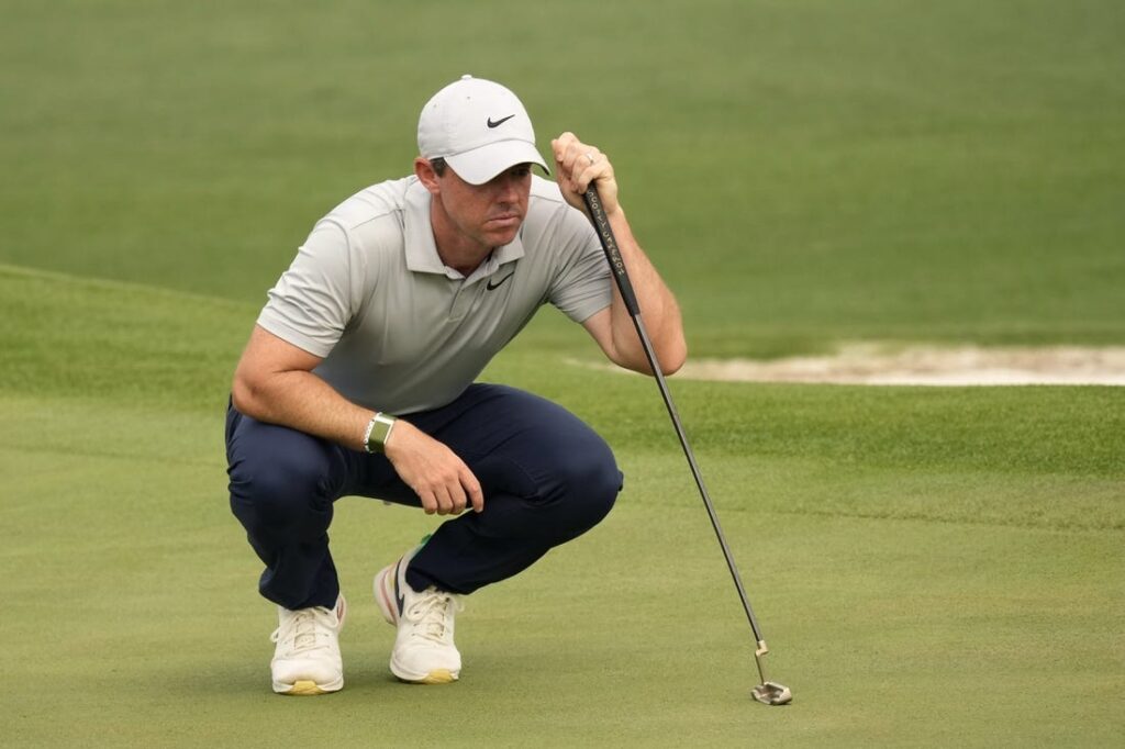 Rory McIlroy reads a green