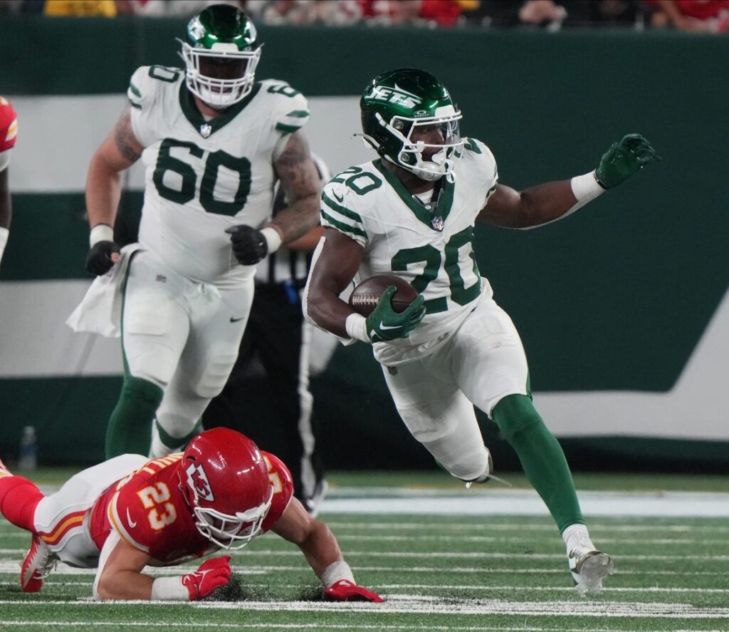 New York Jets running back Breece Hall (20) rushes against Miami