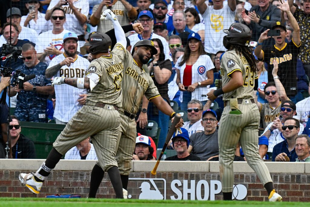 San Diego infielder Manny Machado (13) celebrates with teammates after hitting a two-run home run in the fifth inning against the Chicago Cubs during game two of the Wildcard round for the 2025 MLB playoffs at Wrigley Field. Mandatory Credit:
