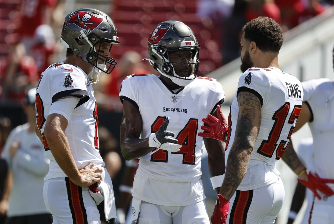 Oct 9, 2022; Tampa, Florida, USA; Tampa Bay Buccaneers quarterback Tom Brady (12), wide receiver Chris Godwin (14) and wide receiver Mike Evans (13) works out prior to the game against the Atlanta Falcons at Raymond James Stadium. Mandatory Credit: Kim Klement-Imagn Images