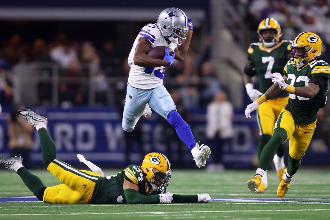 Jan 14, 2024; Arlington, Texas, USA; Dallas Cowboys wide receiver Michael Gallup (13) makes a catch over Green Bay Packers safety Jonathan Owens (34) during the second half of the 2024 NFC wild card game at AT&T Stadium. Mandatory Credit: Tim Heitman-Imagn Images