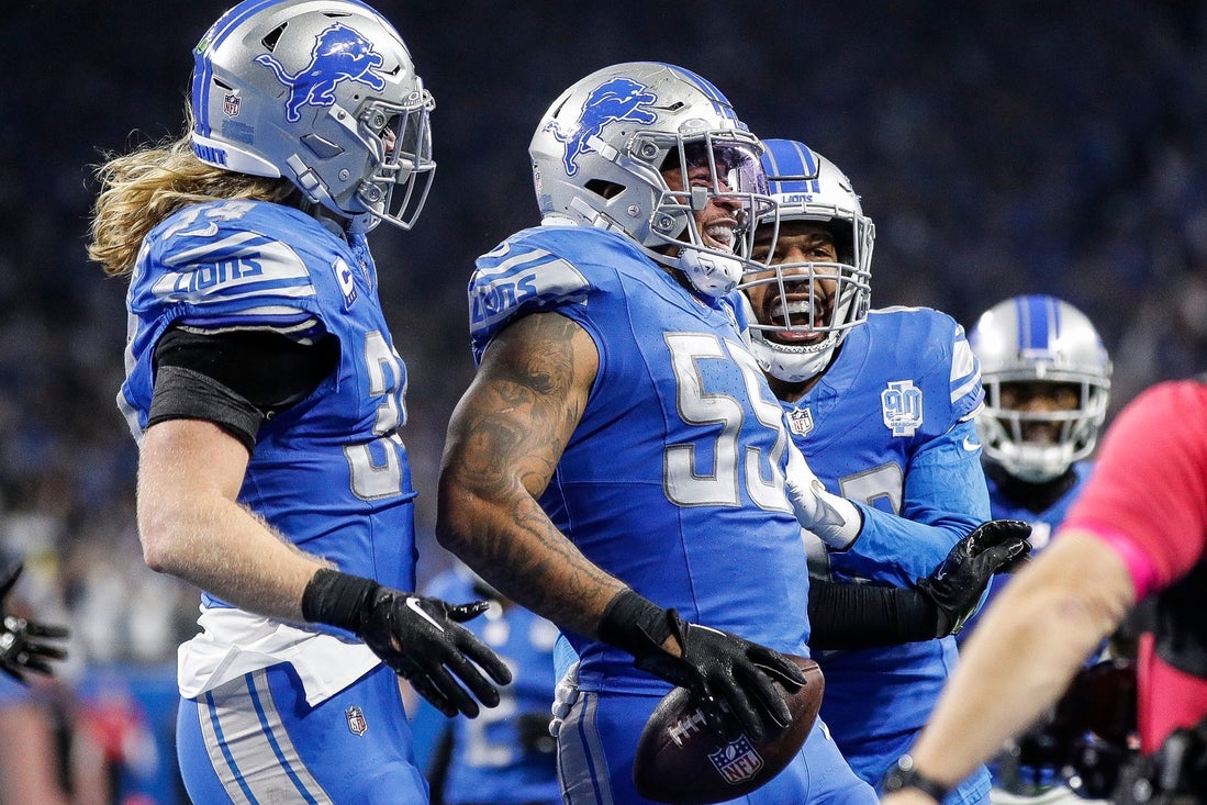 Detroit Lions linebacker Derrick Barnes (55) celebrates an interception from Tampa Bay Buccaneers quarterback Baker Mayfield with linebacker Alex Anzalone (34) and linebacker Jalen Reeves-Maybin (42) during the second half of the NFC divisional round at Ford Field in Detroit on Sunday, Jan. 21, 2024.