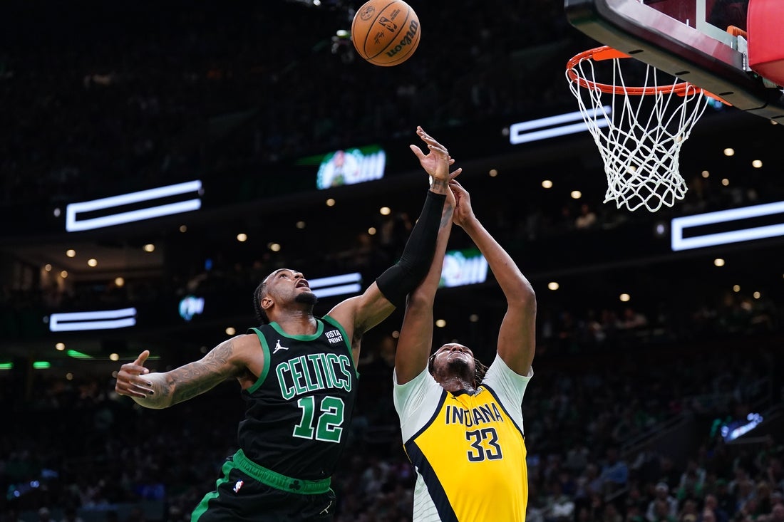 May 23, 2024; Boston, Massachusetts, USA;Boston Celtics forward Oshae Brissett (12) and Indiana Pacers center Myles Turner (33) attempt to get a rebound in the second half during game two of the eastern conference finals for the 2024 NBA playoffs at TD Garden. Mandatory Credit: David Butler II-Imagn Images