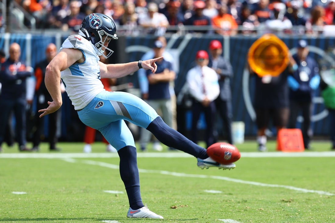 Sep 8, 2024; Chicago, Illinois, USA; Tennessee Titans punter Ryan Stonehouse (4) punts the ball against the Chicago Bears during the first quarter at Soldier Field. Mandatory Credit: Mike Dinovo-Imagn Images