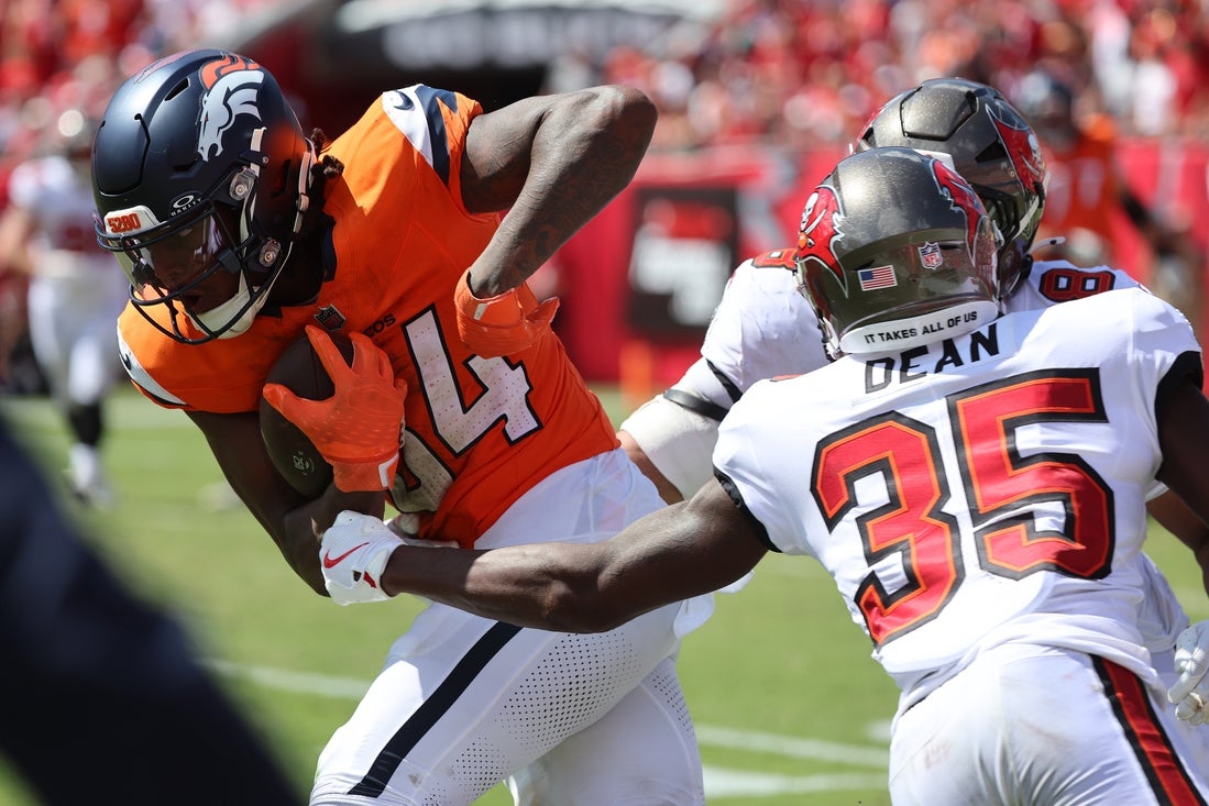 Sep 22, 2024; Tampa, Florida, USA; Denver Broncos wide receiver Lil'Jordan Humphrey (84) runs with the ball as Tampa Bay Buccaneers cornerback Jamel Dean (35) defends during the second half at Raymond James Stadium. Mandatory Credit: Kim Klement Neitzel-Imagn Images