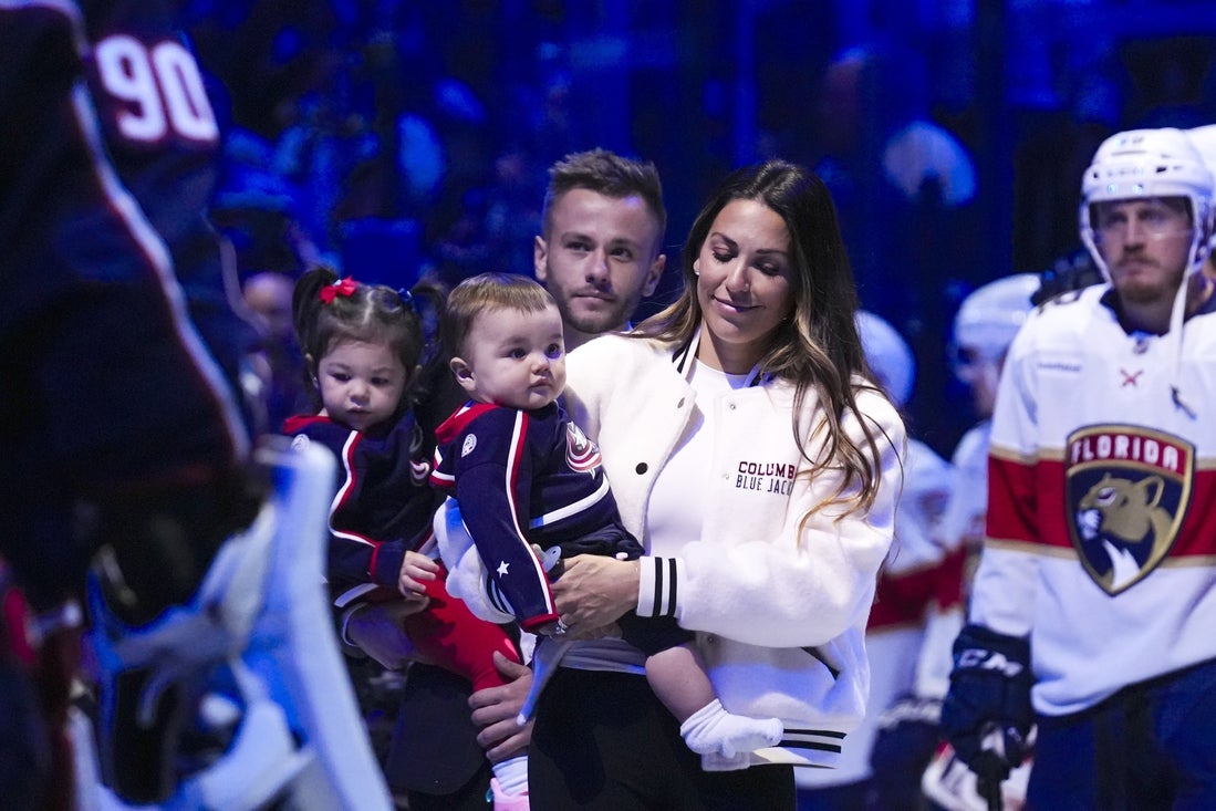Oct 15, 2024; Columbus, Ohio, USA; Johnny Gaudreau's wife Meredith walks out onto the ice with her children and a family member for a memorial for Johnny and Matthew Gaudreau before the home opener at Nationwide Arena. Mandatory Credit: Samantha Mada-Imagn Images