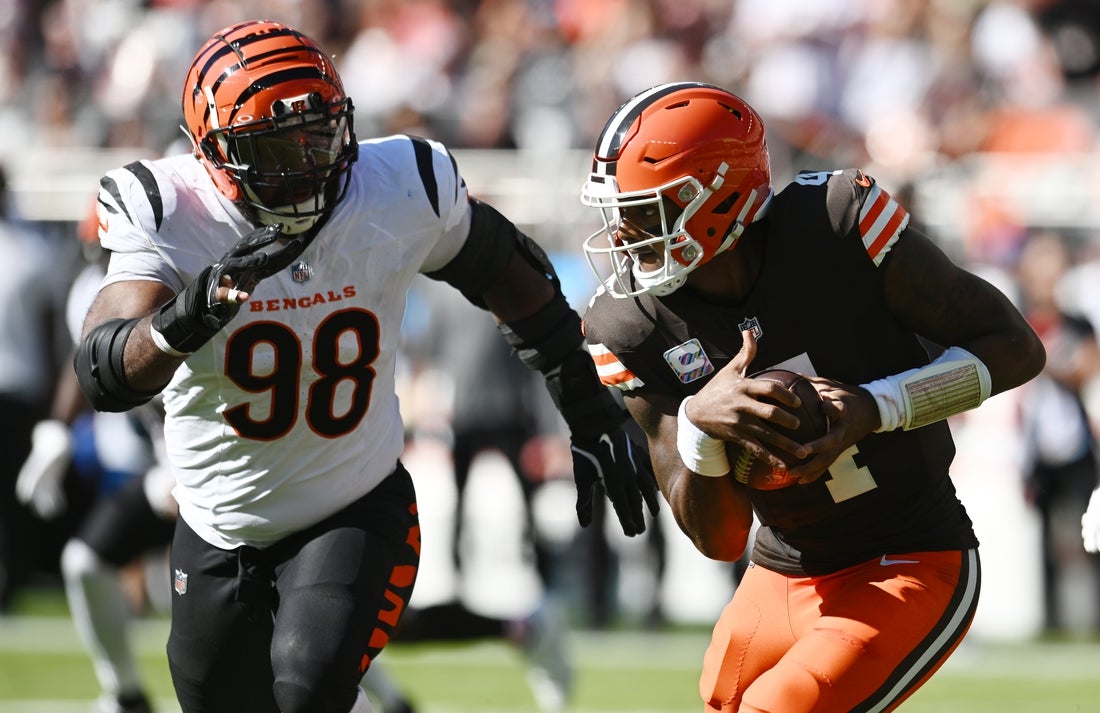 Oct 20, 2024; Cleveland, Ohio, USA; Cleveland Browns quarterback Deshaun Watson (4) runs from Cincinnati Bengals defensive tackle Sheldon Rankins (98) during the first half at Huntington Bank Field. Mandatory Credit: Ken Blaze-Imagn Images
