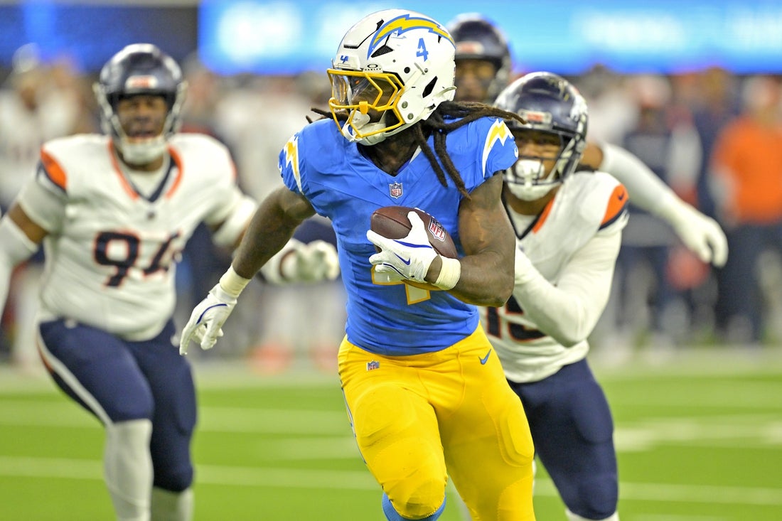 Dec 19, 2024; Inglewood, California, USA; Los Angeles Chargers running back Gus Edwards (4) runs for a touchdown in the second half against the Denver Broncos at SoFi Stadium. Mandatory Credit: Jayne Kamin-Oncea-Imagn Images