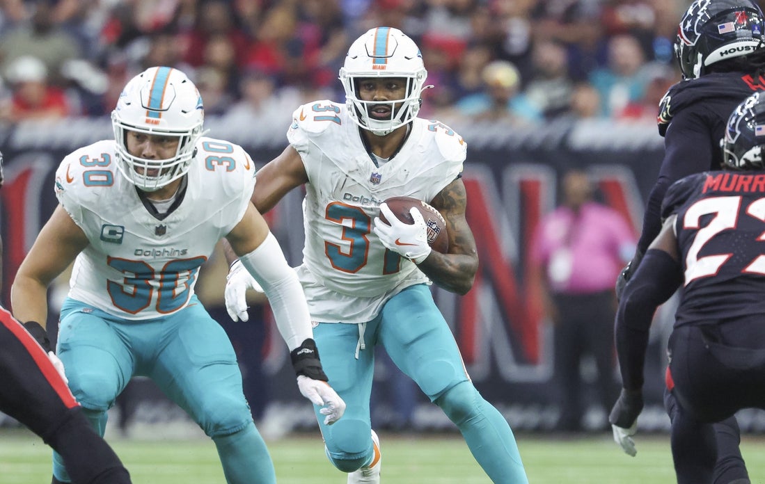 Dec 15, 2024; Houston, Texas, USA; Miami Dolphins running back Raheem Mostert (31) runs with the ball during the game against the Houston Texans at NRG Stadium. Mandatory Credit: Troy Taormina-Imagn Images