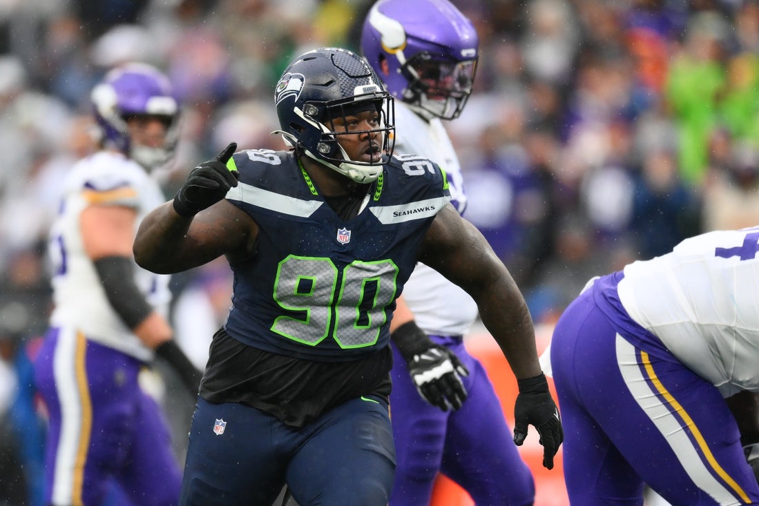 Dec 22, 2024; Seattle, Washington, USA; Seattle Seahawks defensive tackle Jarran Reed (90) celebrates after sacking Minnesota Vikings quarterback Sam Darnold (14) (not pictured) during the first half at Lumen Field. Mandatory Credit: Steven Bisig-Imagn Images