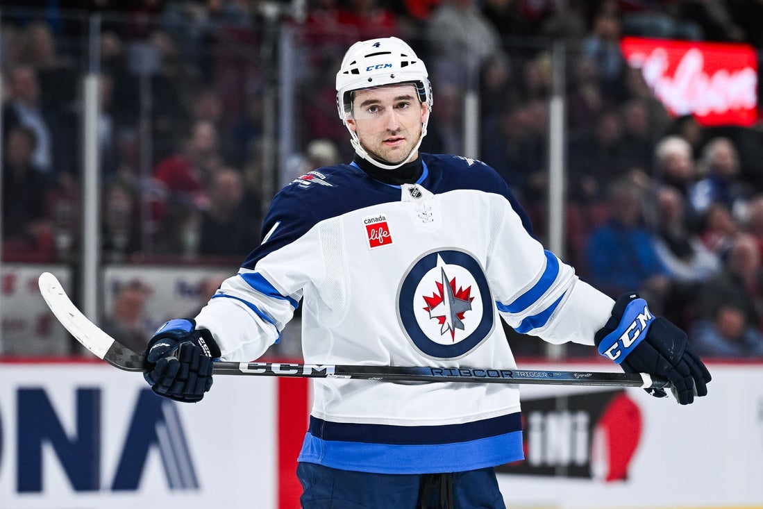 Jan 28, 2025; Montreal, Quebec, CAN; Winnipeg Jets defenseman Neal Pionk (4) looks on against the Montreal Canadiens during the third period at Bell Centre. Mandatory Credit: David Kirouac-Imagn Images