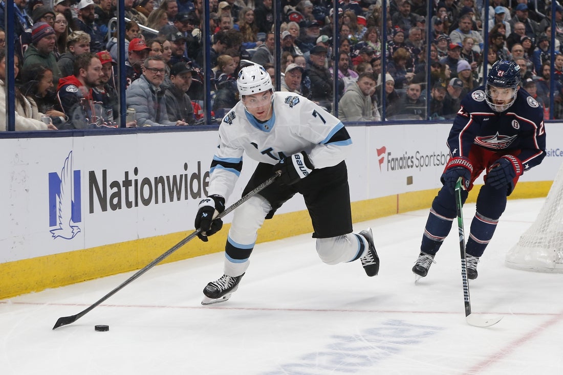 Utah Hockey Club defenseman Michael Kesselring (7) looks to pass against Columbus Blue Jackets left wing James van Riemsdyk (21) during the first period at Nationwide Arena.
