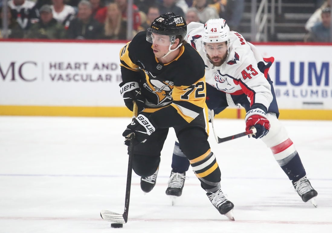Feb 22, 2025; Pittsburgh, Pennsylvania, USA; Pittsburgh Penguins left wing Anthony Beauvillier (72) moves the puck up the ice ahead of Washington Capitals right wing Tom Wilson (43) during the first period at PPG Paints Arena. Mandatory Credit: Charles LeClaire-Imagn Images