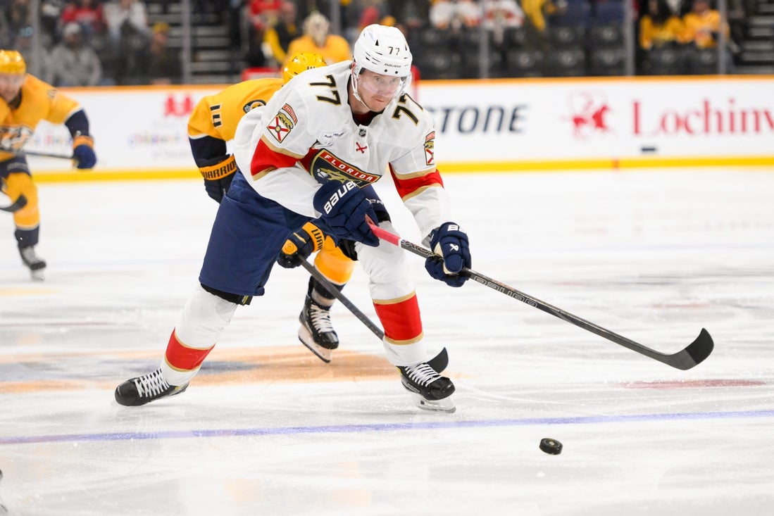 Feb 25, 2025; Nashville, Tennessee, USA; Florida Panthers defenseman Niko Mikkola (77) skates with the puck against the Nashville Predators during the second period at Bridgestone Arena. Mandatory Credit: Steve Roberts-Imagn Images