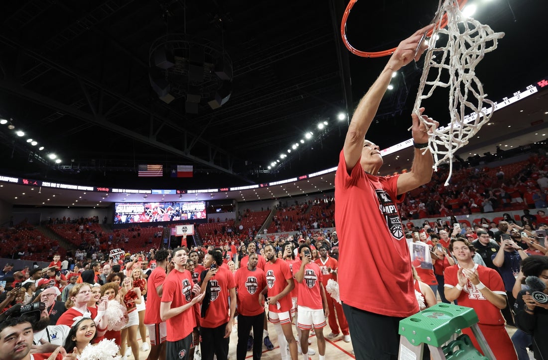 Mar 1, 2025; Houston, Texas, USA; Houston Cougars head coach Kelvin Sampson cuts down the net and celebrates after winning the Big 12 Conference after defeating the Cincinnati Bearcats at Fertitta Center. Mandatory Credit: Thomas Shea-Imagn Images