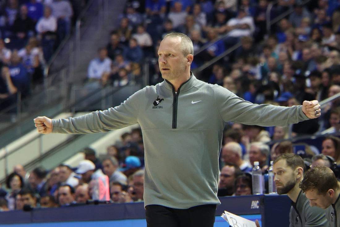 iMar 1, 2025; Provo, Utah, USA; West Virginia Mountaineers head coach Darian DeVries calls a play against the Brigham Young Cougars during the first half at Marriott Center. Mandatory Credit: Rob Gray-Imagn Images
