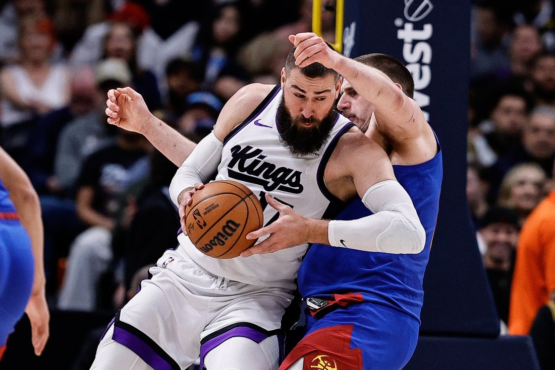 Mar 5, 2025; Denver, Colorado, USA; Sacramento Kings center Jonas Valanciunas (17) knocks Denver Nuggets center Nikola Jokic (15) to the court in the second quarter at Ball Arena. Mandatory Credit: Isaiah J. Downing-Imagn Images