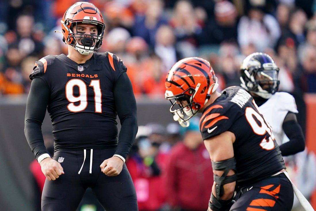 Cincinnati Bengals defensive end Trey Hendrickson (91), left, and Cincinnati Bengals defensive end Sam Hubbard (94) celebrate a sack in the second quarter during a Week 16 NFL game against the Baltimore Ravens, Sunday, Dec. 26, 2021, at Paul Brown Stadium in Cincinnati.