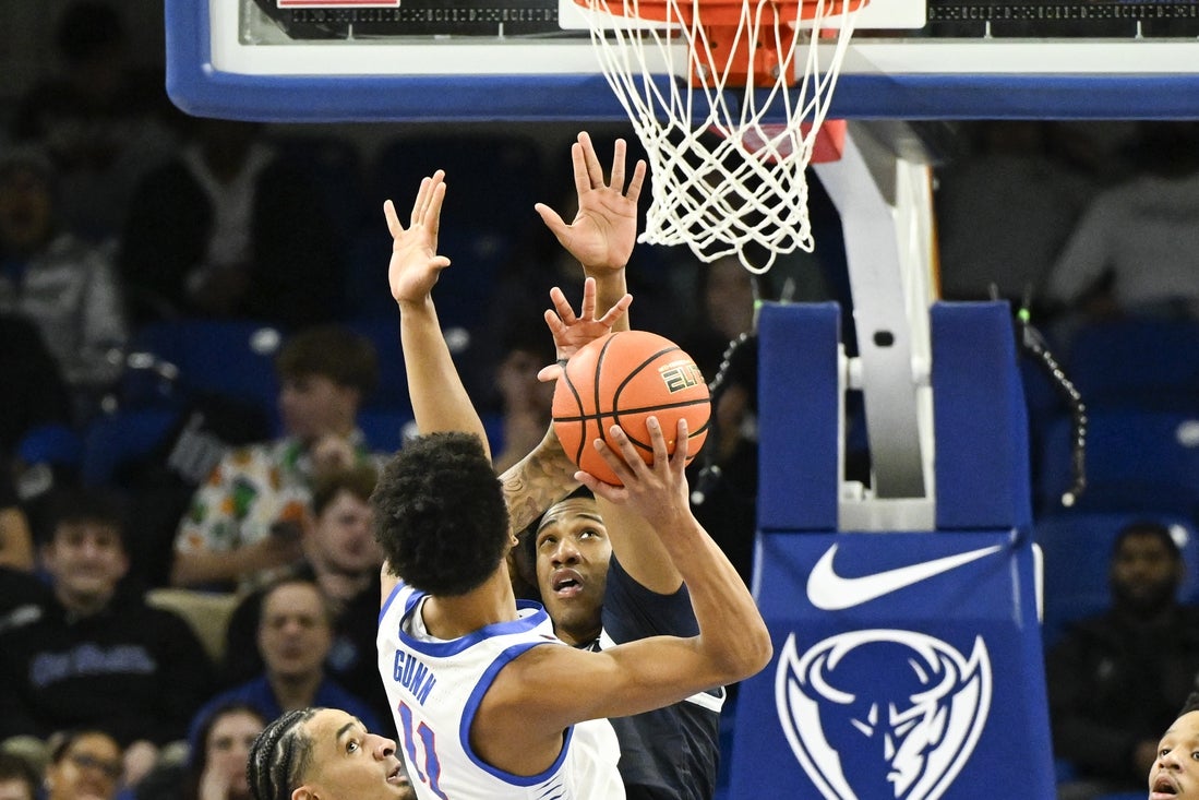 Mar 8, 2025; Chicago, Illinois, USA; Georgetown Hoyas forward Drew McKenna (7) defends against DePaul Blue Demons guard CJ Gunn (11) during the first half at Wintrust Arena. Mandatory Credit: Matt Marton-Imagn Images