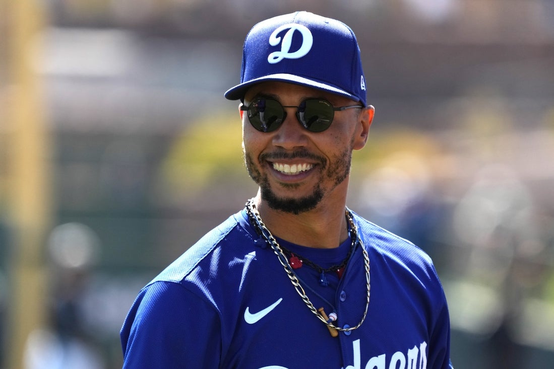 Mar 8, 2025; Phoenix, Arizona, USA; Los Angeles Dodgers shortstop Mookie Betts (50) warms up before a game against the Chicago White Sox at Camelback Ranch-Glendale. Mandatory Credit: Rick Scuteri-Imagn Images