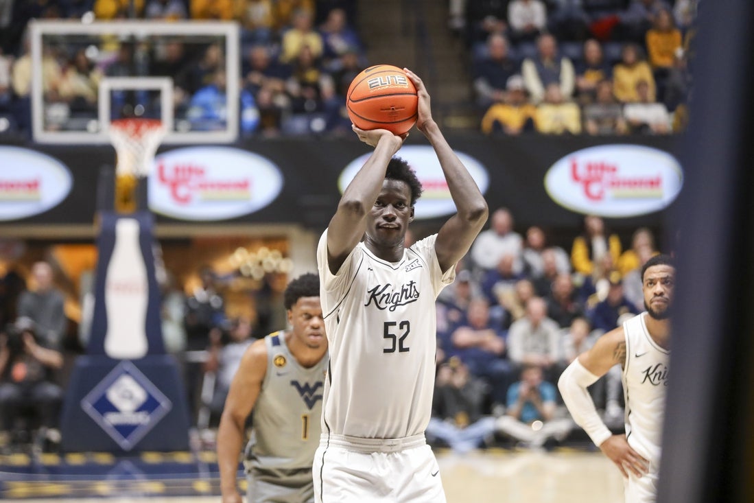 Mar 8, 2025; Morgantown, West Virginia, USA; UCF Knights center Moustapha Thiam (52) shoots a free throw during the second half .a2. at WVU Coliseum. Mandatory Credit: Ben Queen-Imagn Images