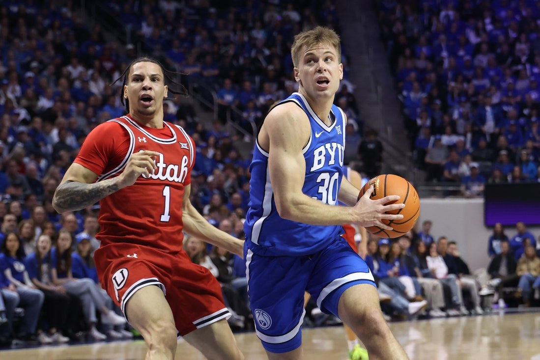 Mar 8, 2025; Provo, Utah, USA; Brigham Young Cougars guard Dallin Hall (30) drives against Utah Utes guard Miro Little (1) during the first half at Marriott Center. Mandatory Credit: Rob Gray-Imagn Images