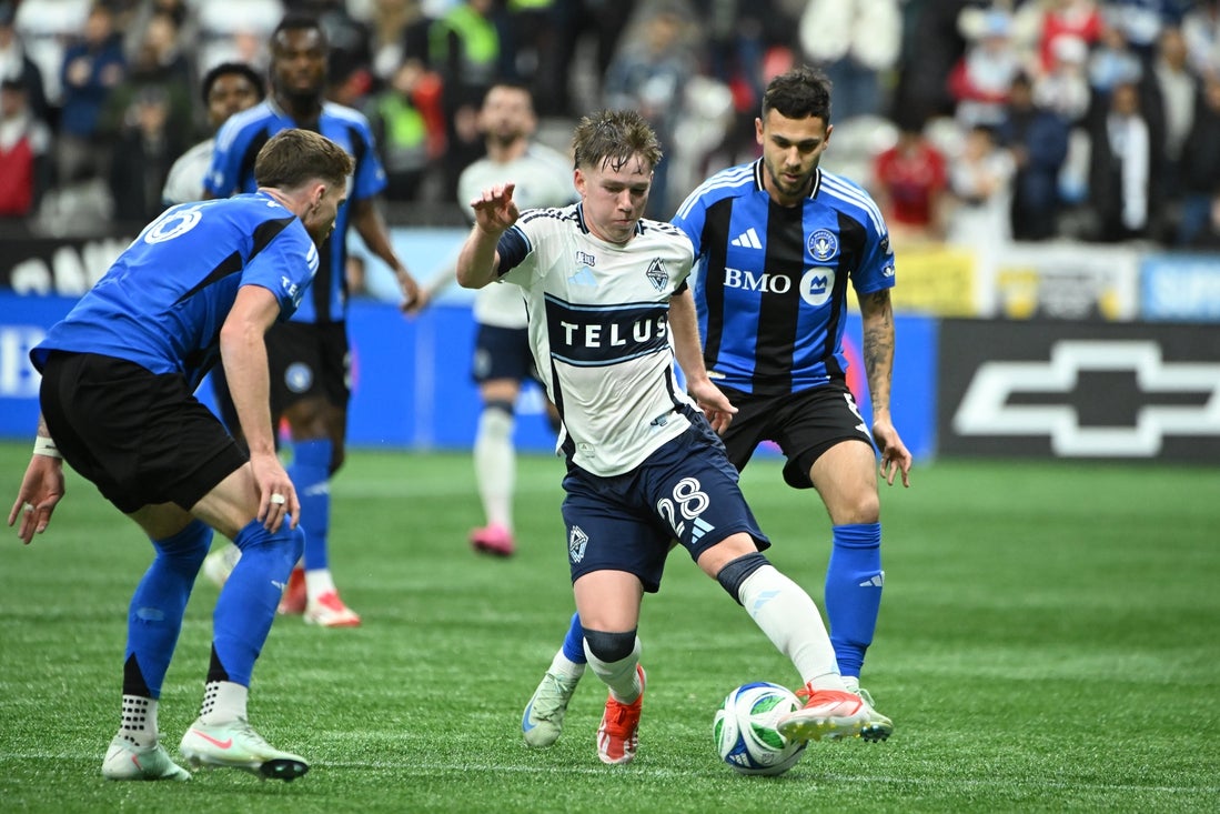 Mar 8, 2025; Vancouver, British Columbia, CAN; Vancouver Whitecaps FC defender Tate Johnson (28) dribbles the ball against CF Montreal midfielder Dominic Iankov (8) during the second half at BC Place. Mandatory Credit: Simon Fearn-Imagn Images