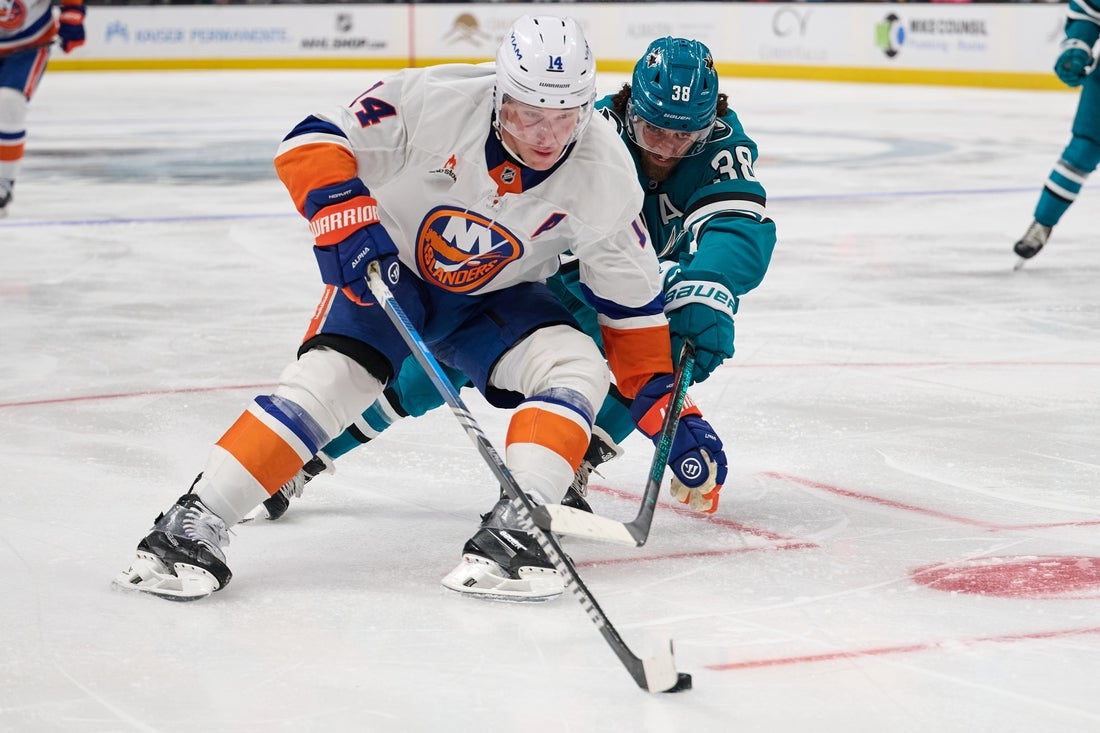 Mar 8, 2025; San Jose, California, USA; New York Islanders center Bo Horvat (14) controls the puck against San Jose Sharks defenseman Mario Ferraro (38) during the third period at SAP Center at San Jose. Mandatory Credit: Robert Edwards-Imagn Images