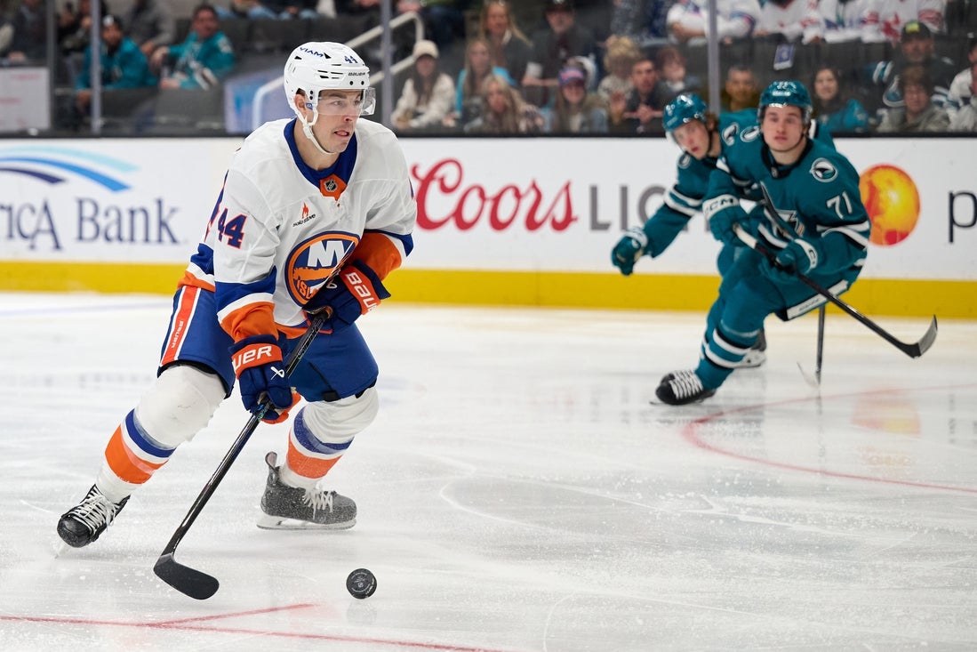 Mar 8, 2025; San Jose, California, USA; New York Islanders center Jean-Gabriel Pageau (44) controls the puck against San Jose Sharks center Macklin Celebrini (71) and defenseman Henry Thrun (3) during the first period at SAP Center at San Jose. Mandatory Credit: Robert Edwards-Imagn Images