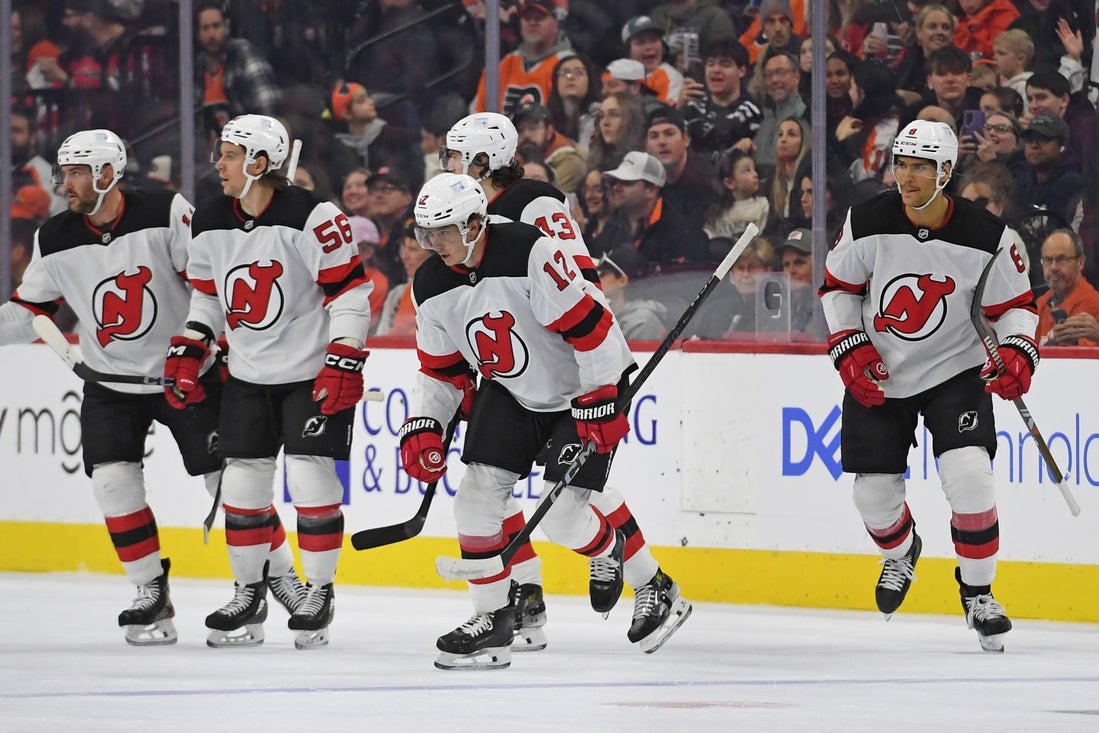 Mar 9, 2025; Philadelphia, Pennsylvania, USA; New Jersey Devils center Cody Glass (12) skates back to the bench after scoring a goal against the Philadelphia Flyers during the first period at Wells Fargo Center. Mandatory Credit: Eric Hartline-Imagn Images