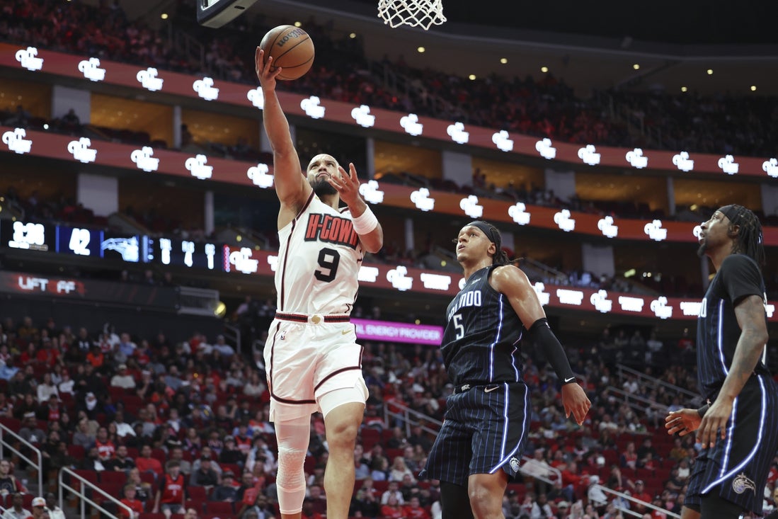 Mar 10, 2025; Houston, Texas, USA; Houston Rockets forward Dillon Brooks (9) shoots the ball as Orlando Magic forward Paolo Banchero (5) defends during the second quarter at Toyota Center. Mandatory Credit: Troy Taormina-Imagn Images