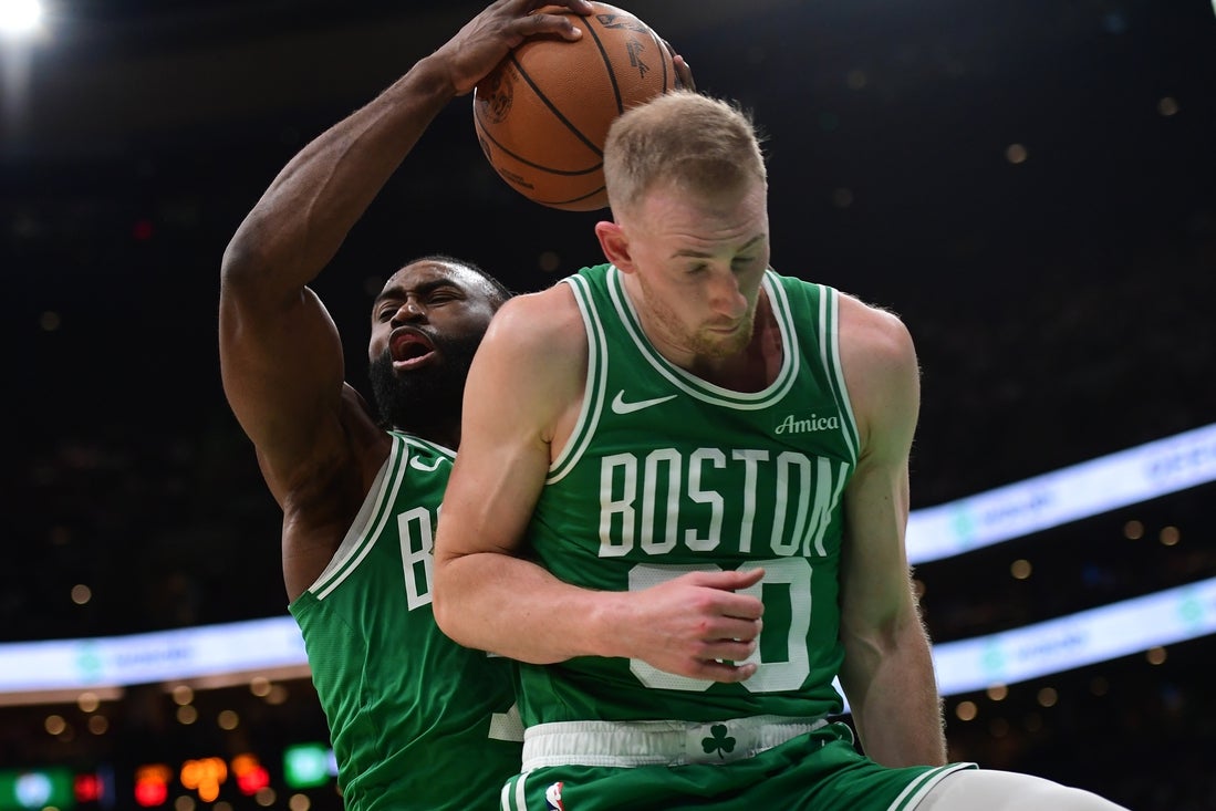 Mar 10, 2025; Boston, Massachusetts, USA; Boston Celtics guard Jaylen Brown (7) grabs a rebound in front of forward Sam Hauser (30) during the second half at TD Garden. Mandatory Credit: Bob DeChiara-Imagn Images