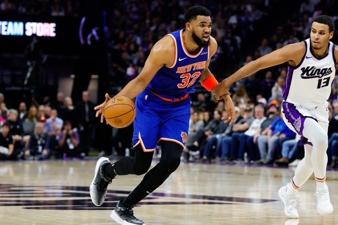 Mar 10, 2025; Sacramento, California, USA; New York Knicks center Karl-Anthony Towns (32) dribbles the ball against Sacramento Kings forward Keegan Murray (13) during the second quarter at Golden 1 Center. Mandatory Credit: Sergio Estrada-Imagn Images