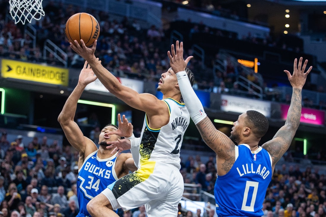 Mar 11, 2025; Indianapolis, Indiana, USA; Indiana Pacers guard Andrew Nembhard (2)shoots the ball while Milwaukee Bucks forward Giannis Antetokounmpo (34) and guard Damian Lillard (0) defend in the first half at Gainbridge Fieldhouse. Mandatory Credit: Trevor Ruszkowski-Imagn Images