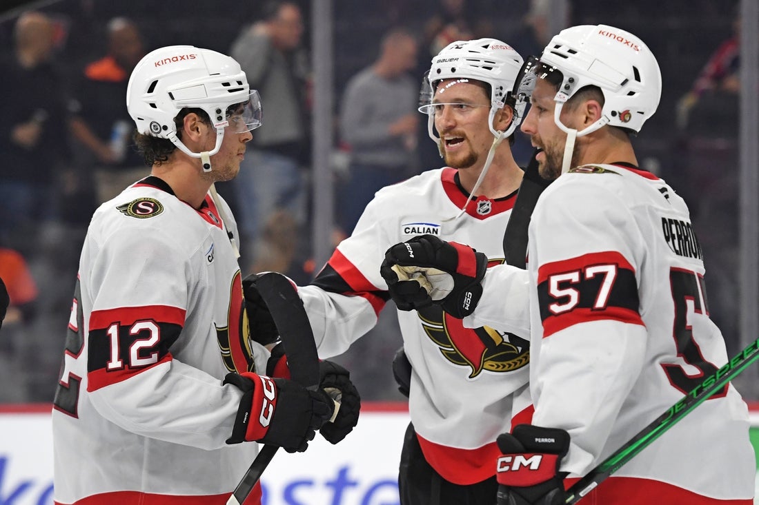Mar 11, 2025; Philadelphia, Pennsylvania, USA; Ottawa Senators center Shane Pinto (12), defenseman Thomas Chabot (72) and left wing David Perron (57) celebrate win against the Philadelphia Flyers at Wells Fargo Center. Mandatory Credit: Eric Hartline-Imagn Images