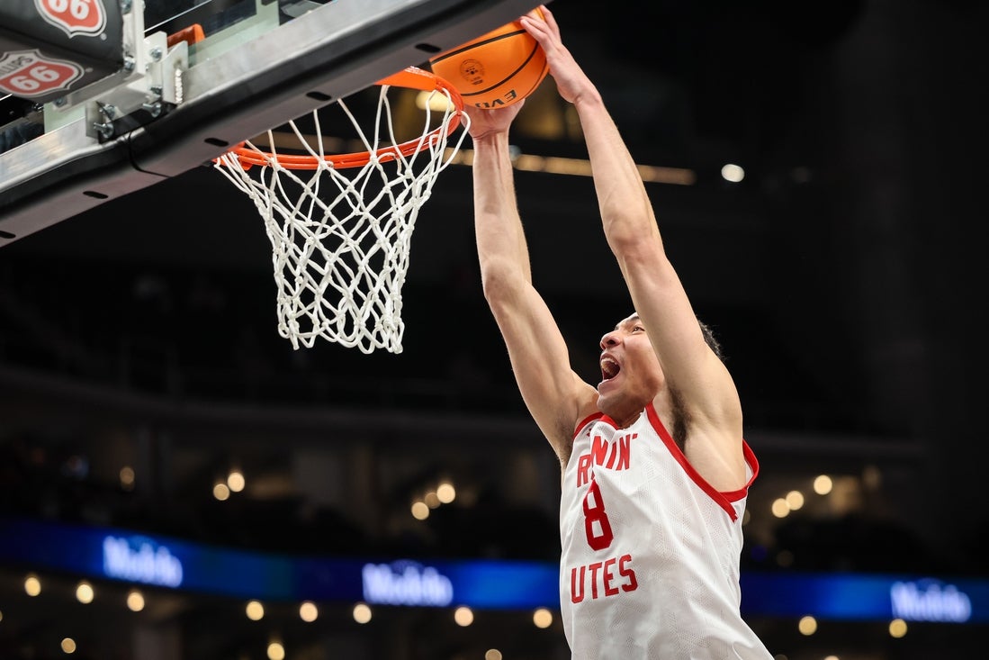 Mar 11, 2025; Kansas City, MO, USA; Utah Utes forward Keanu Dawes (8) dunks during the first half against the UCF Knights at T-Mobile Center. Mandatory Credit: William Purnell-Imagn Images