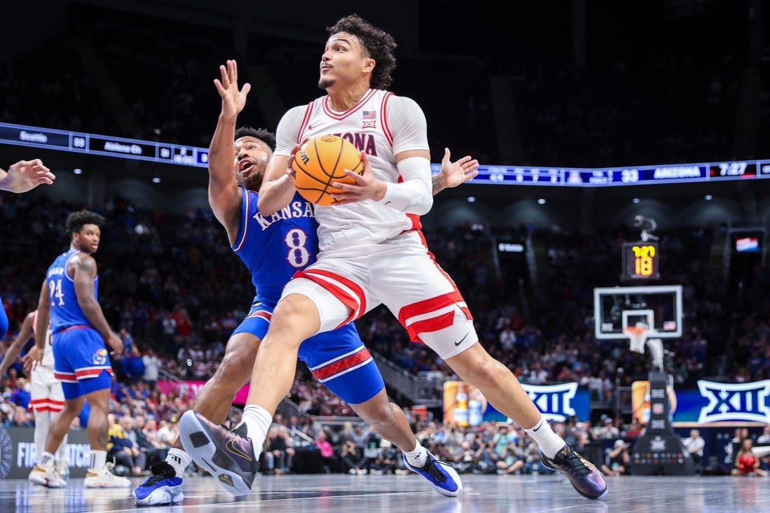 Mar 13, 2025; Kansas City, MO, USA; Arizona Wildcats forward Trey Townsend (4) drives to the basket around Kansas Jayhawks guard David Coit (8) during the first half at T-Mobile Center. Mandatory Credit: William Purnell-Imagn Images