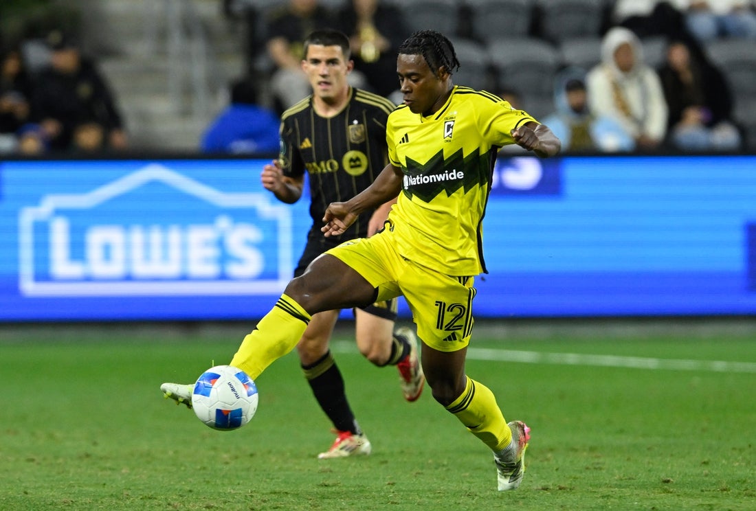 Mar 4, 2025; Los Angeles, California, USA; Columbus Crew forward DeJuan Jones (12) controls the ball against Los Angeles FC defender Sergi Palencia (14) during the second half at BMO Stadium. Mandatory Credit: Alex Gallardo-Imagn Images