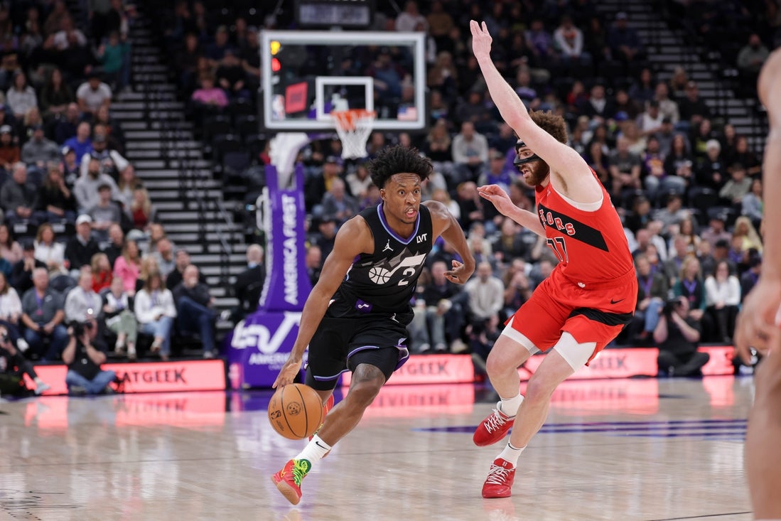 Mar 14, 2025; Salt Lake City, Utah, USA; Utah Jazz guard Collin Sexton (2) runs up the court while guarded by Toronto Raptors forward Jamison Battle (77) during the first quarter at Delta Center. Mandatory Credit: Chris Nicoll-Imagn Images