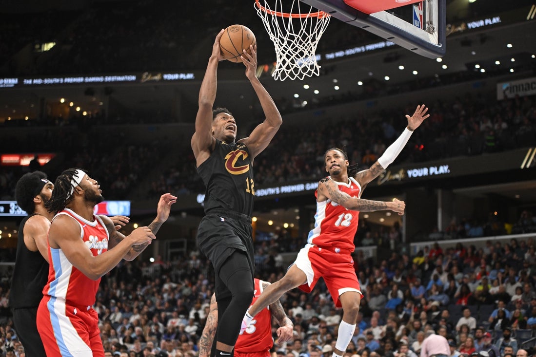 Mar 14, 2025; Memphis, Tennessee, USA; Cleveland Cavaliers small forward De'Andre Hunter (12) dunks the ball in the middle of several defenders in the 3rd quarter of the Cleveland Cavaliers vs. Memphis Grizzlies game at FedExForum. Mandatory Credit: Matthew Smith-Imagn Images