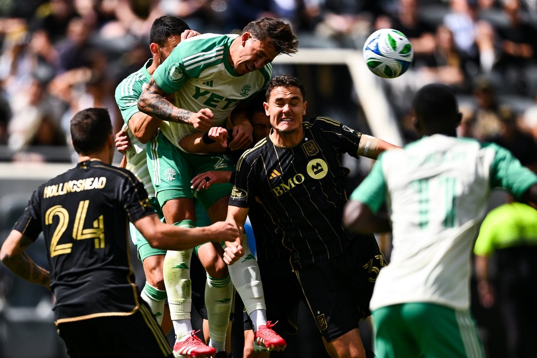Mar 15, 2025; Los Angeles, California, USA; Austin FC defender Guilherme Biro (29) scores a goal on a corner kick against Los Angeles FC defender Aaron Long (33) during the first half at BMO Stadium. Mandatory Credit: Kelvin Kuo-Imagn Images