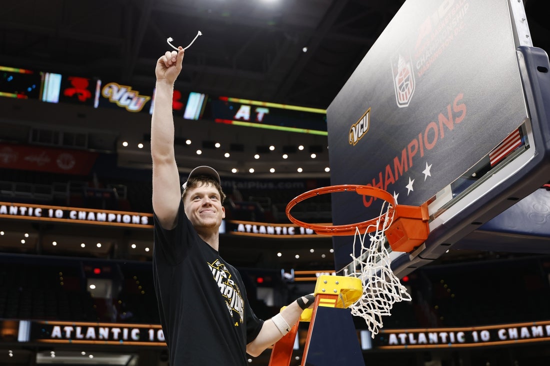 Mar 16, 2025; Washington, D.C., USA; A10 player of the year, VCU Rams guard Max Shulga, holds a piece of the net during the championship trophy ceremony after their game against the George Mason Patriots at Capital One Arena. Mandatory Credit: Geoff Burke-Imagn Images