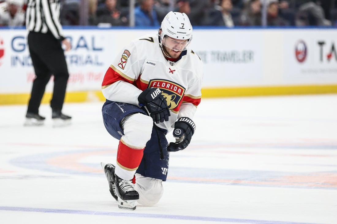 Mar 16, 2025; Elmont, New York, USA; Florida Panthers defenseman Dmitry Kulikov (7) gets up off the ice following a collision in the first period against the New York Islanders at UBS Arena. Mandatory Credit: Wendell Cruz-Imagn Images