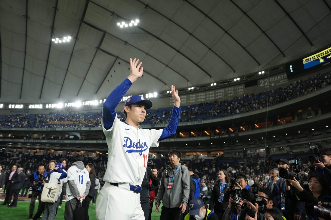 Mar 19, 2025; Bunkyo, Tokyo, JPN; Los Angeles Dodgers starting pitcher Roki Sasaki (11) waves to the crowd after defeating the Chicago Cubs during the Tokyo Series at Tokyo Dome. Mandatory Credit: Darren Yamashita-Imagn Images