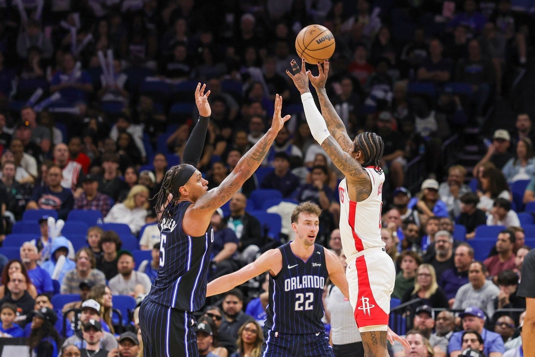 Mar 19, 2025; Orlando, Florida, USA; Houston Rockets guard Jalen Green (4) shoots against Orlando Magic forward Paolo Banchero (5) during the second quarter at Kia Center. Mandatory Credit: Mike Watters-Imagn Images