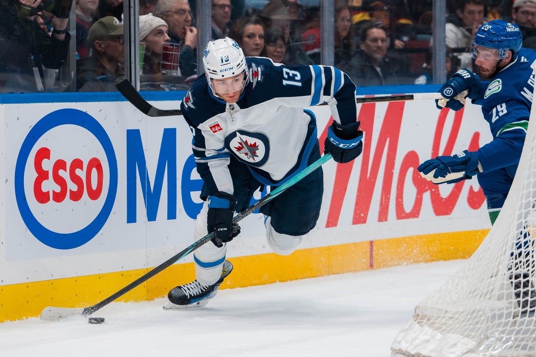 Mar 18, 2025; Vancouver, British Columbia, CAN; Vancouver Canucks defenseman Marcus Pettersson (29) defends against Winnipeg Jets forward Gabriel Vilardi (13) in the first period at Rogers Arena. Mandatory Credit: Bob Frid-Imagn Images