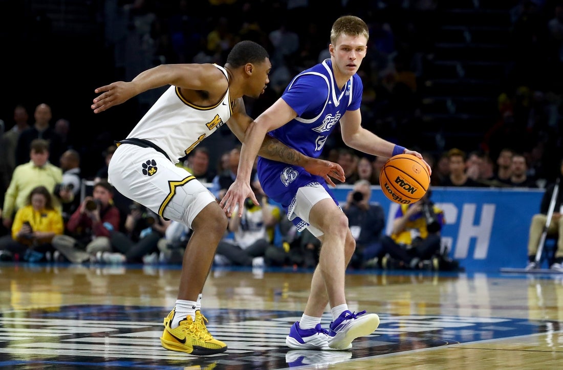 Mar 20, 2025; Wichita, KS, USA; Drake Bulldogs guard Bennett Stirtz (14) dribbles against Missouri Tigers guard Tony Perkins (12) in the first half of a first round men’s NCAA Tournament game at Intrust Bank Arena. Mandatory Credit: Nick Tre. Smith-Imagn Images