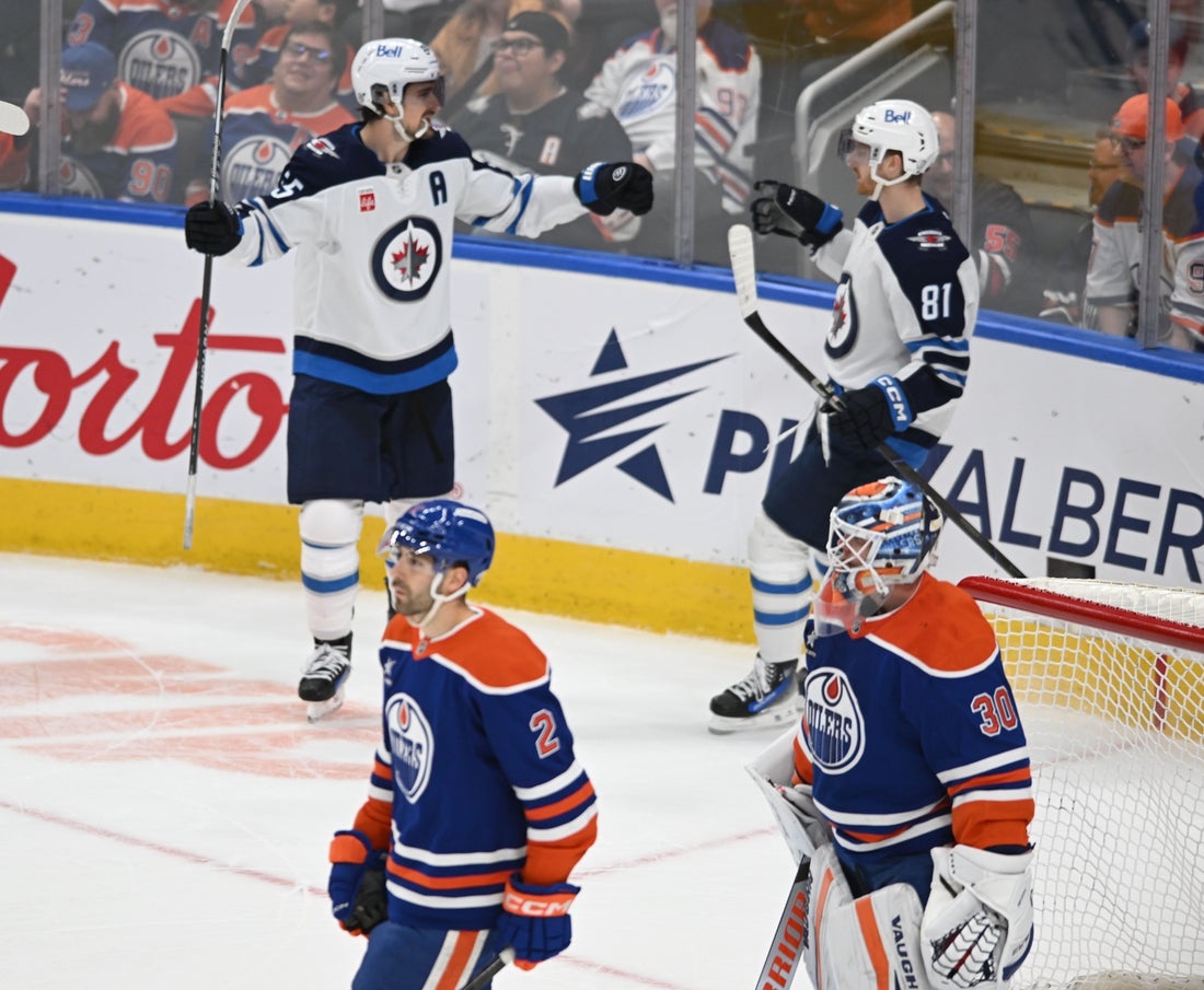 Mar 20, 2025; Edmonton, Alberta, CAN; Winnipeg Jets center Mark Scheifele (55) and Jets left wingwer Kyle Connor (81) celebrate their win on the Edmonton Oilers during the overtime period at Rogers Place. Mandatory Credit: Walter Tychnowicz-Imagn Images