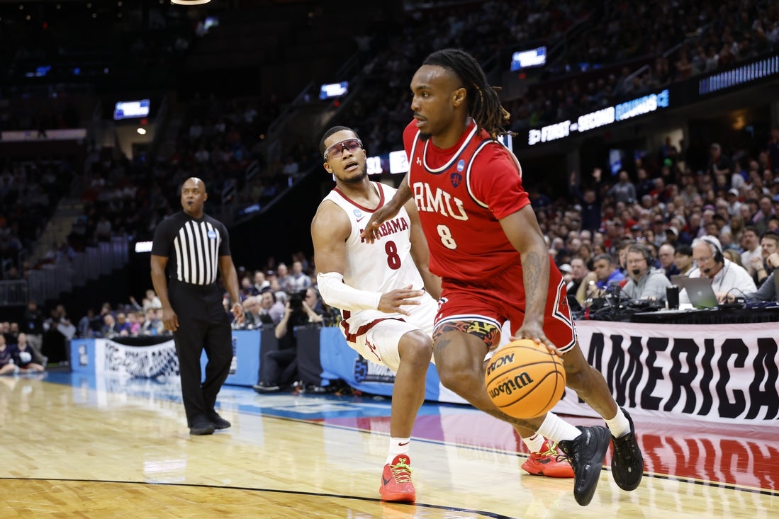 Mar 21, 2025; Cleveland, OH, USA; Robert Morris Colonials guard Kam Woods (8) dribbles in the first half against the Alabama Crimson Tide during the NCAA Tournament First Round at Rocket Arena. Mandatory Credit: Rick Osentoski-Imagn Images